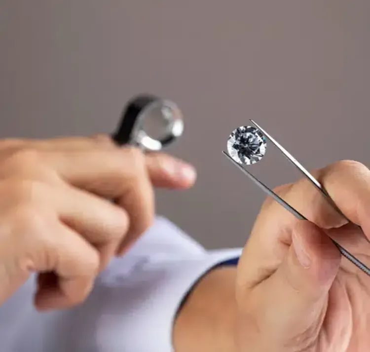 Person inspecting a diamond