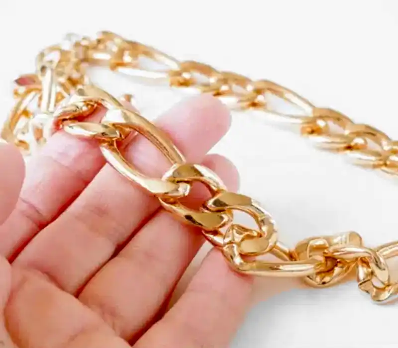 Gold Necklace in a persons hand